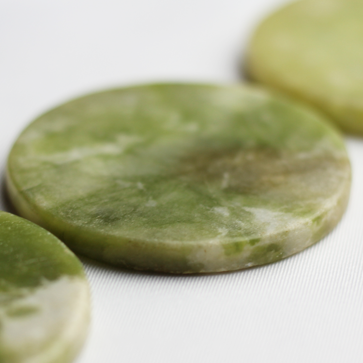 Green jade stones used for holding adhesive